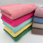 Waved urban rib knit fabric by the yard - folded fabric stacks in pastel and neutral colorways
