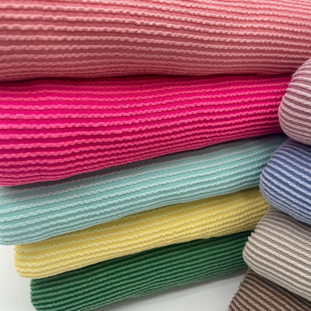Waved urban rib knit fabric by the yard - pastel wavy rib knit texture detail