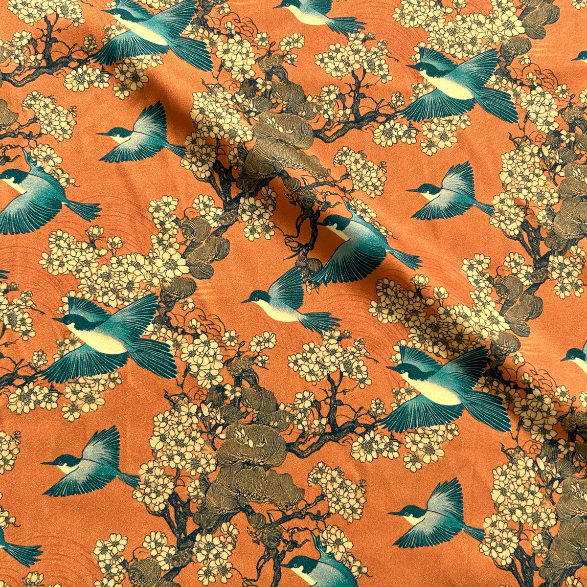 Orange and teal oriental fabric close-up texture detail