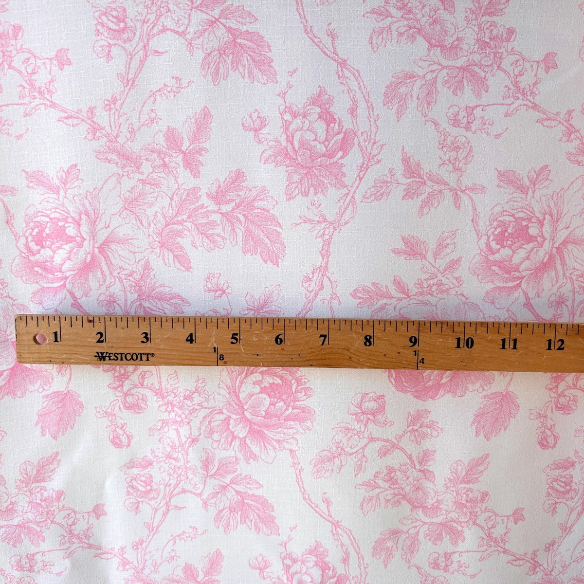 Pink premier prints toile fabric folded view