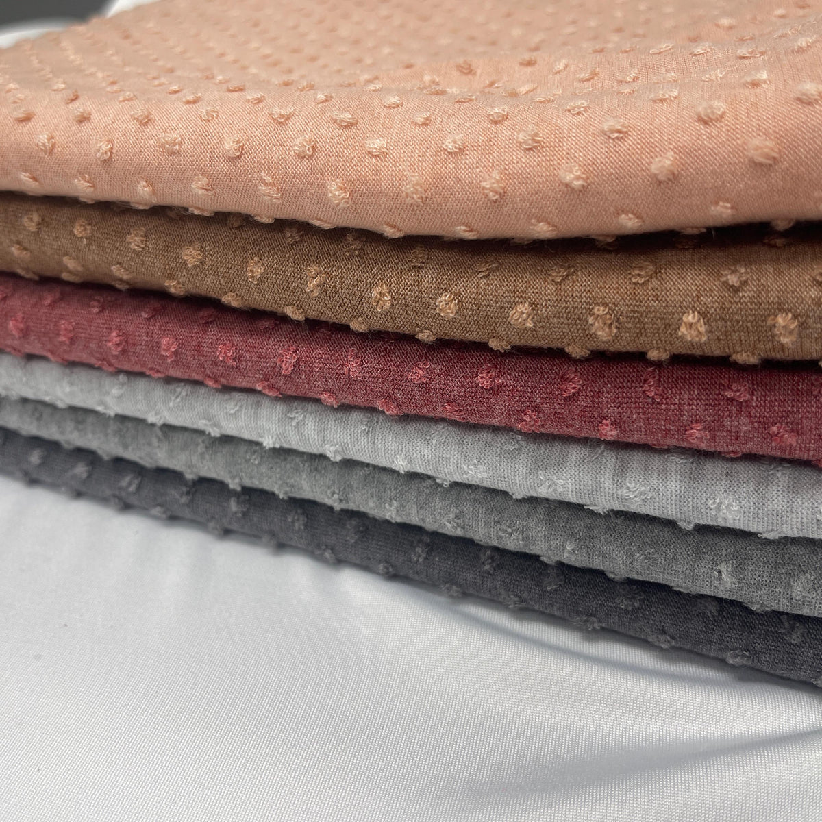 Swiss dot jacquard knit fabric flat lay view