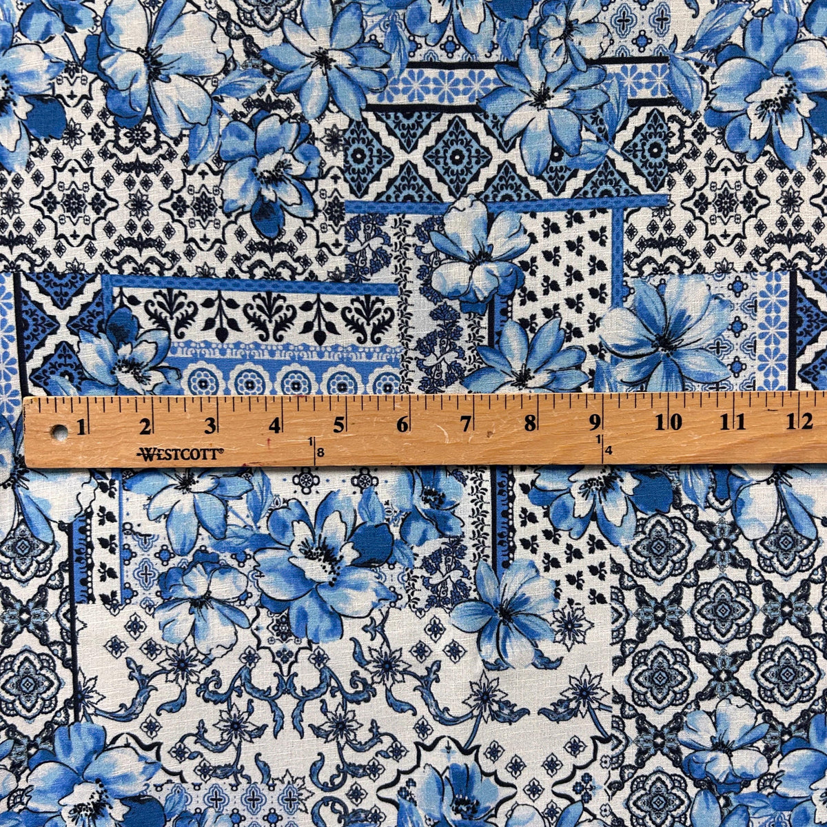 Blue majolica sicilian tile fabric flat lay view