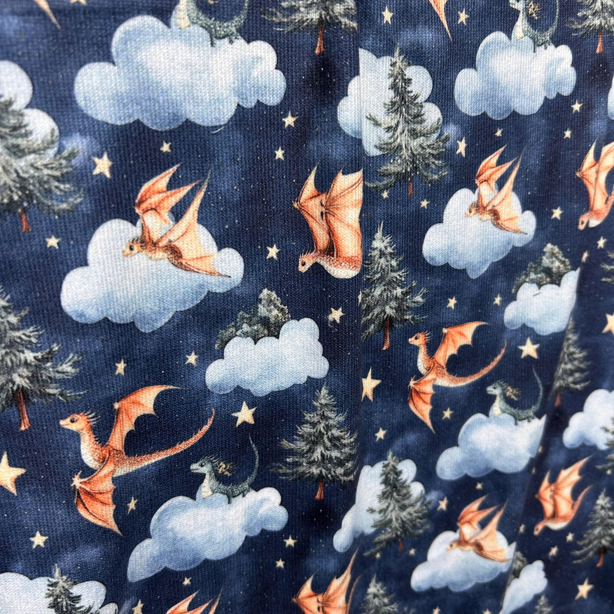 Night fantasy baby dragon fabric flat lay view