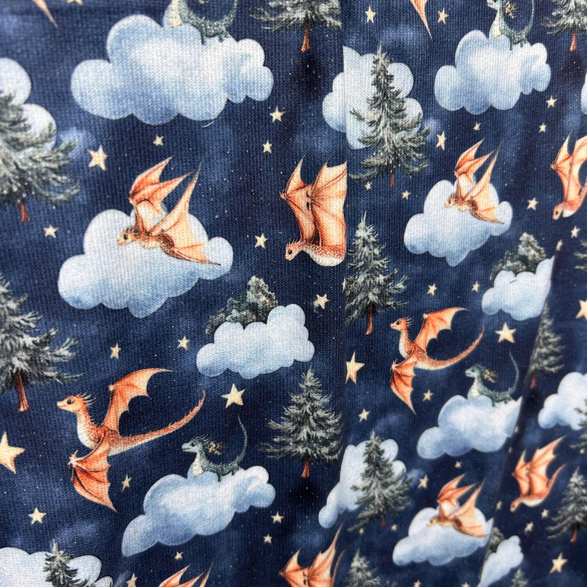 Baby dragon fantasy nursery fabric flat lay view