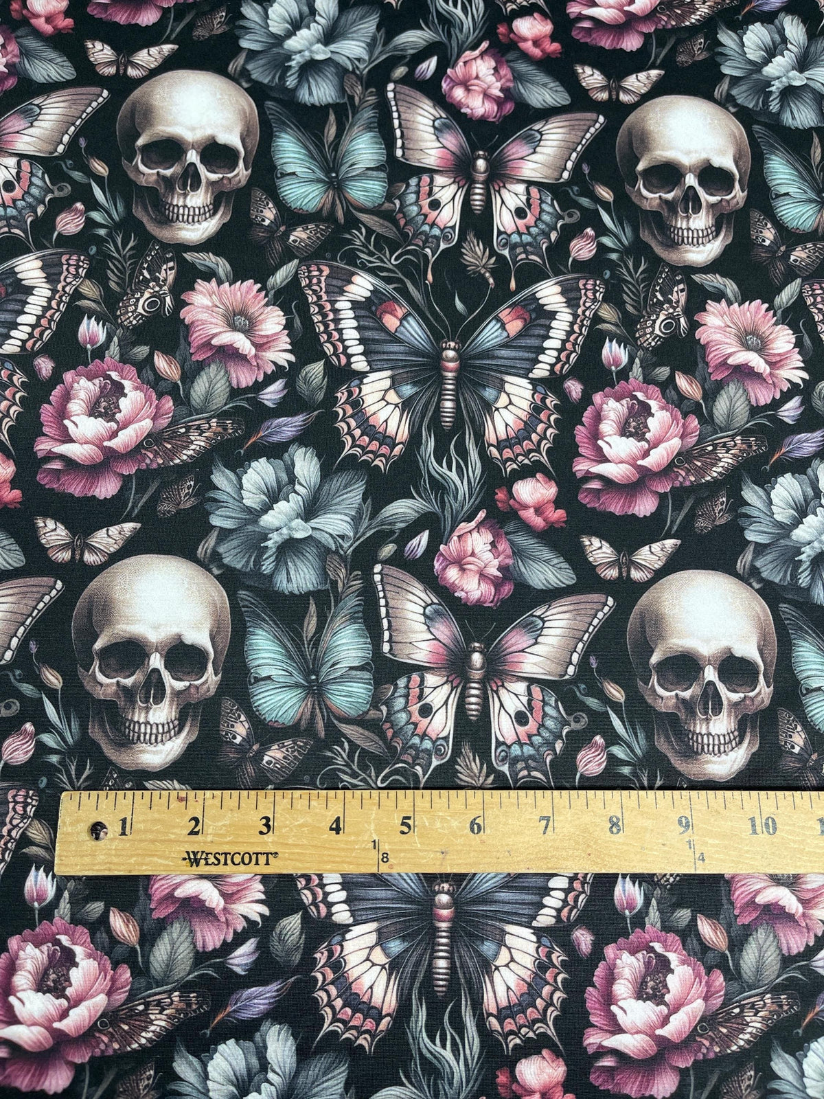 Floral gothic skull fabric flat lay view