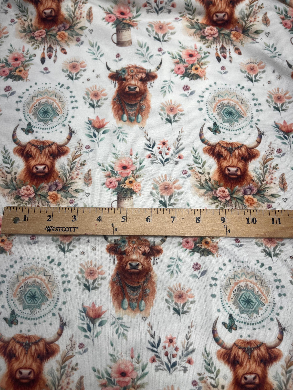 Boho highland cow floral fabric close-up texture detail