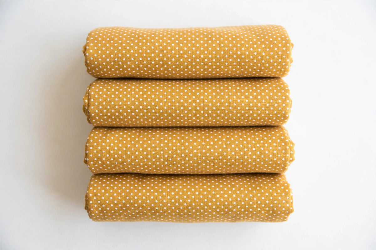 Mustard Polka Dot Cotton — Folded stack view